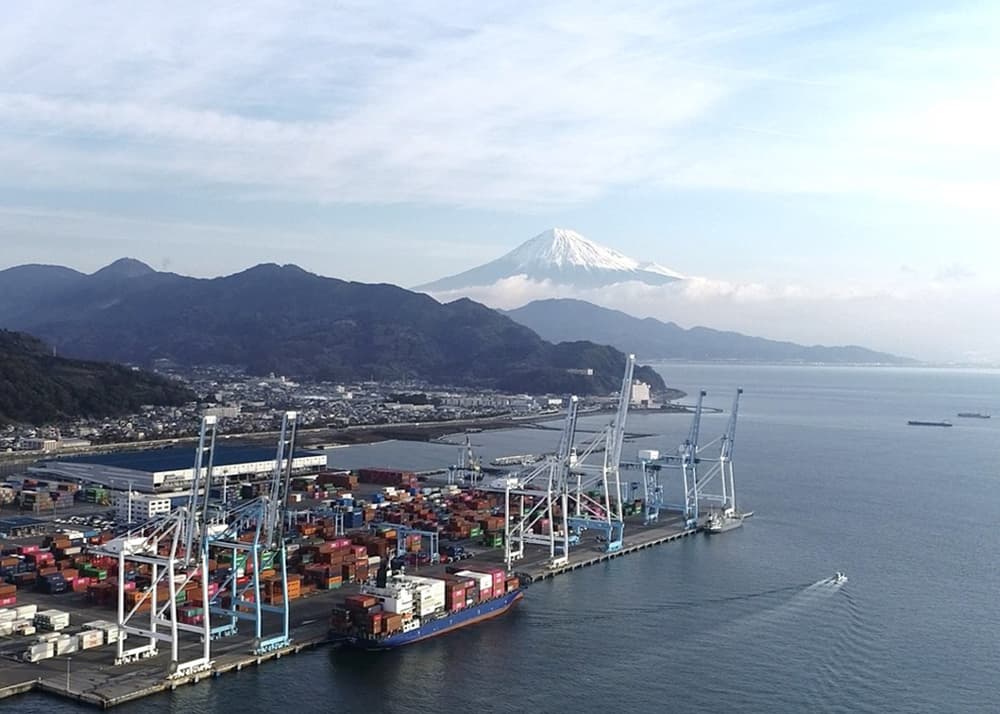 A busy shipping port with cranes and containers